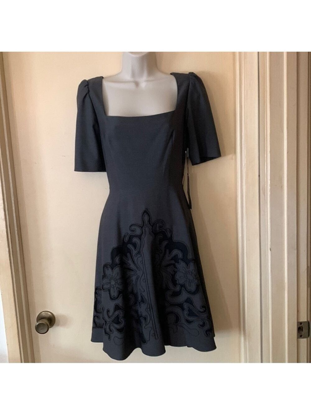 Steve Madden grey scoop neck dress with black appliqué on bottom. Size 2